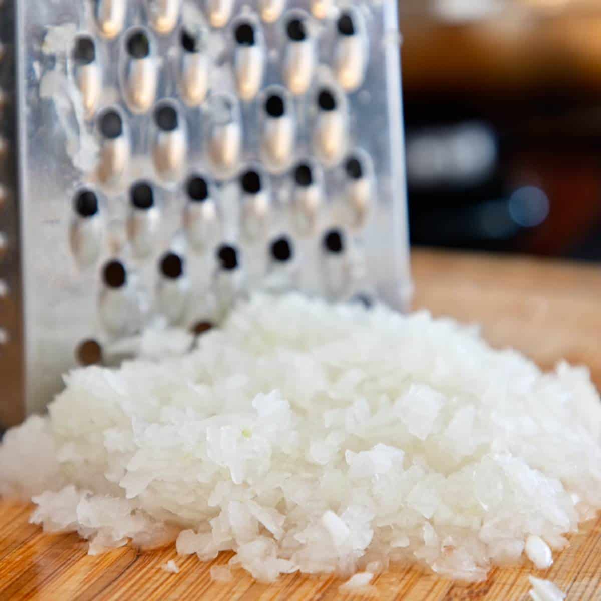 Grated onions on a wooden board.