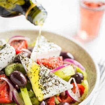 Greek salad in white bowl.