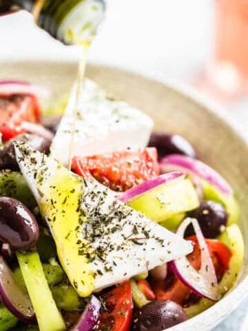 Greek salad in white bowl.