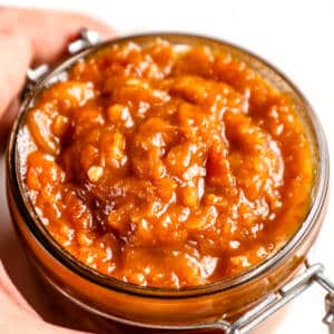 Apricot chilli chutney on a glass jar.