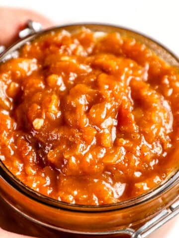 Apricot chilli chutney on a glass jar.