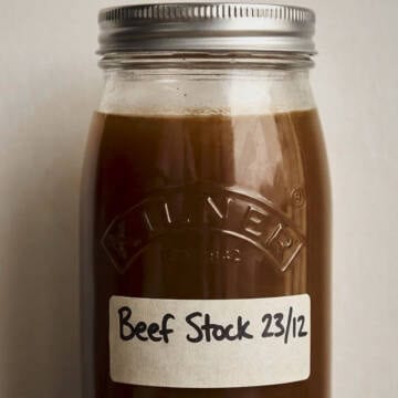 Labeled beef stock in a glass jar.