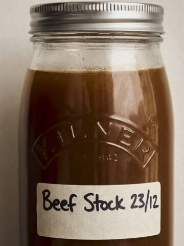Labeled beef stock in a glass jar.