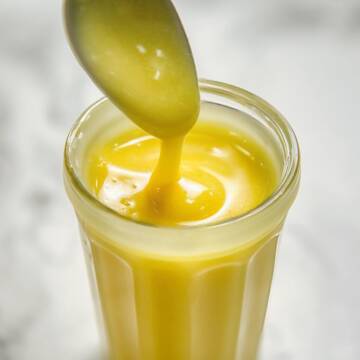 Honey mustard dressing in a glass jar.