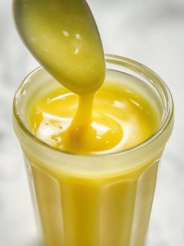 Honey mustard dressing in a glass jar.