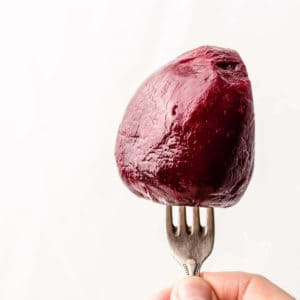 Peeled and boiled red beetroot on a fork.