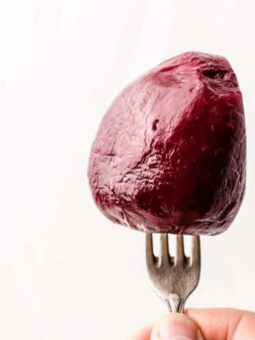 peeled and cooked red beetroot on a fork