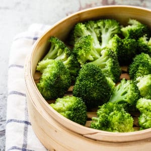 cooked broccoli in a steamer basket