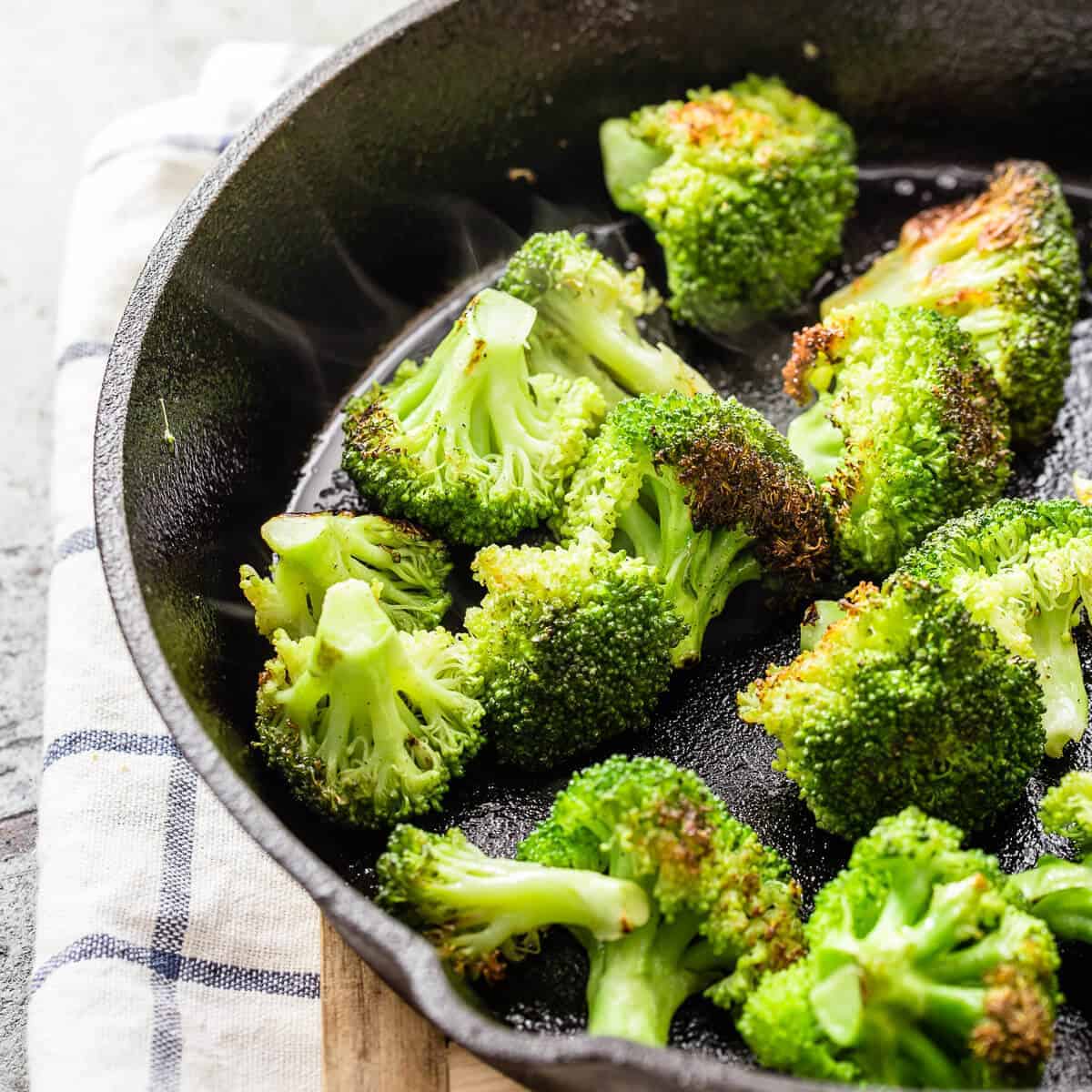 cooked broccoli in a cast iron pan