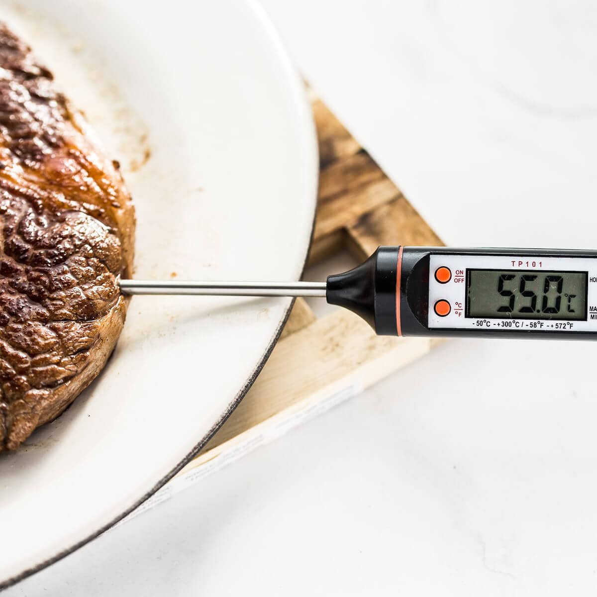 Meat thermometer showing the temperature of a ribeye steak once cooked.