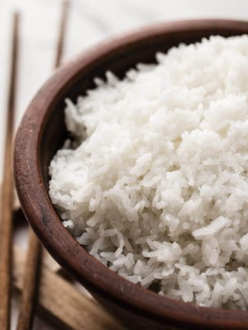 cooked rice in a brown bowl