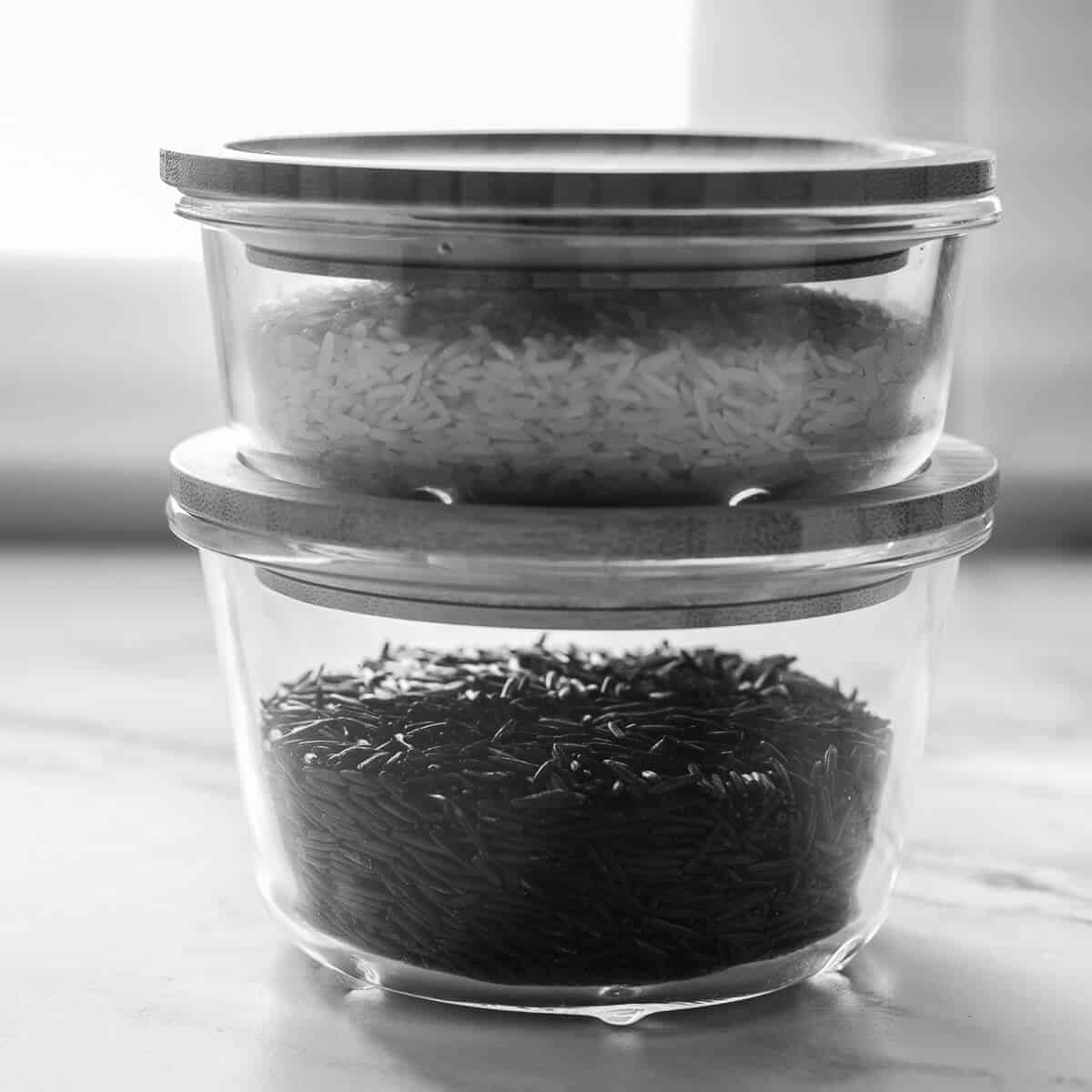 Black and white photo of wild and basmati rice on a window ledge.