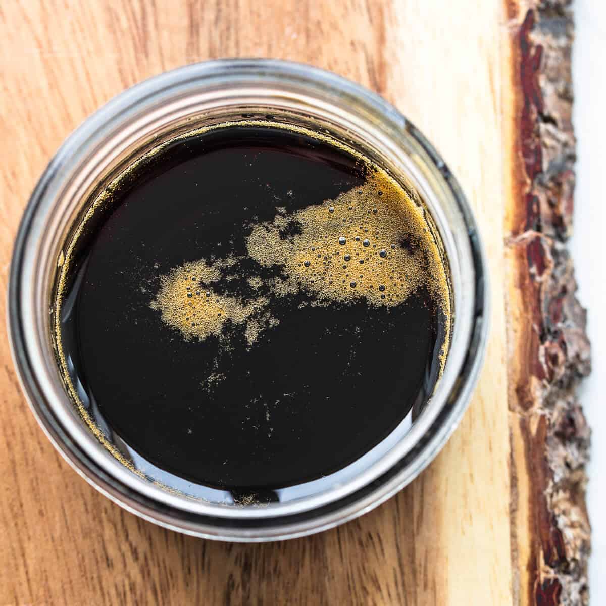 Kacap manis in glass jar on wooden board