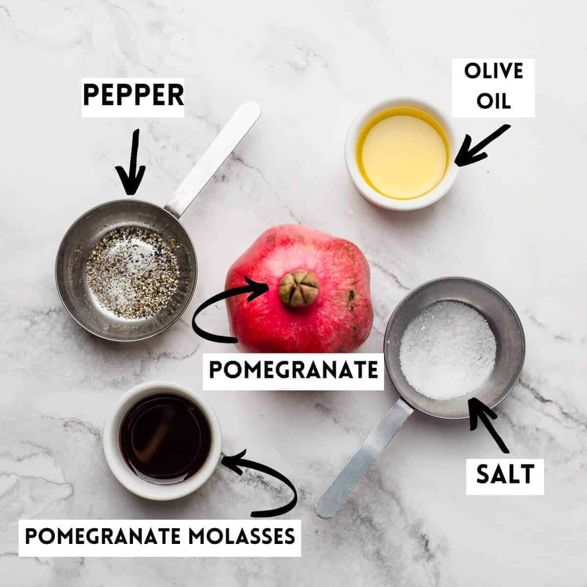 pomegranate, olive oil, salt, molasses and ground pepper on marble 