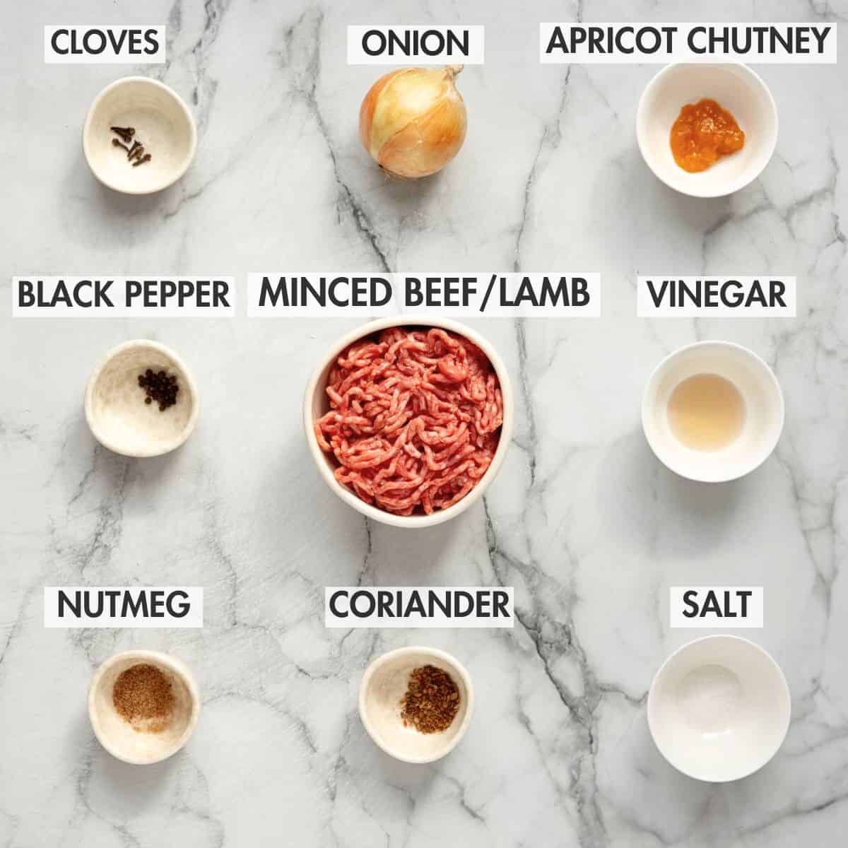 Ingredients for frikkadels on a marble background.