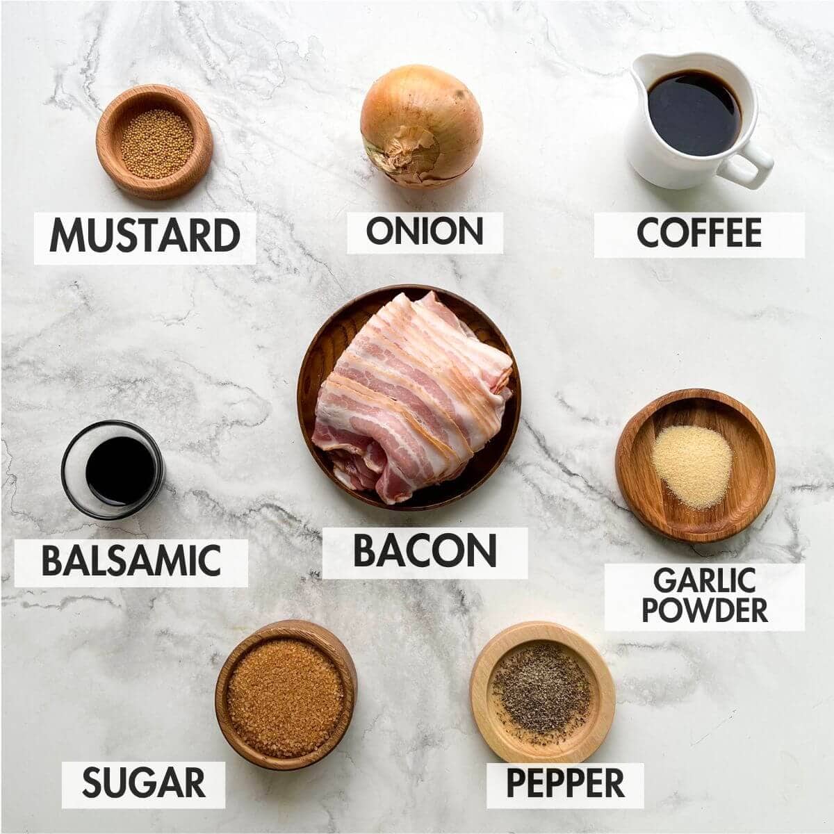 Ingredients for bacon jam on a marble background.