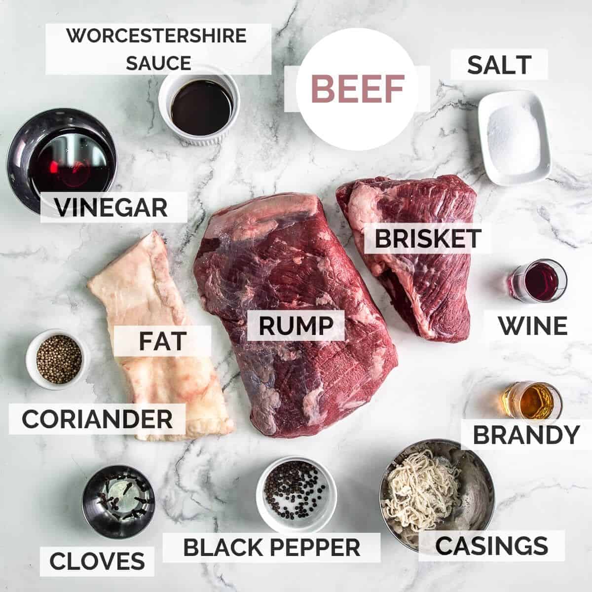 ingredients for making beef droewors on a marble background