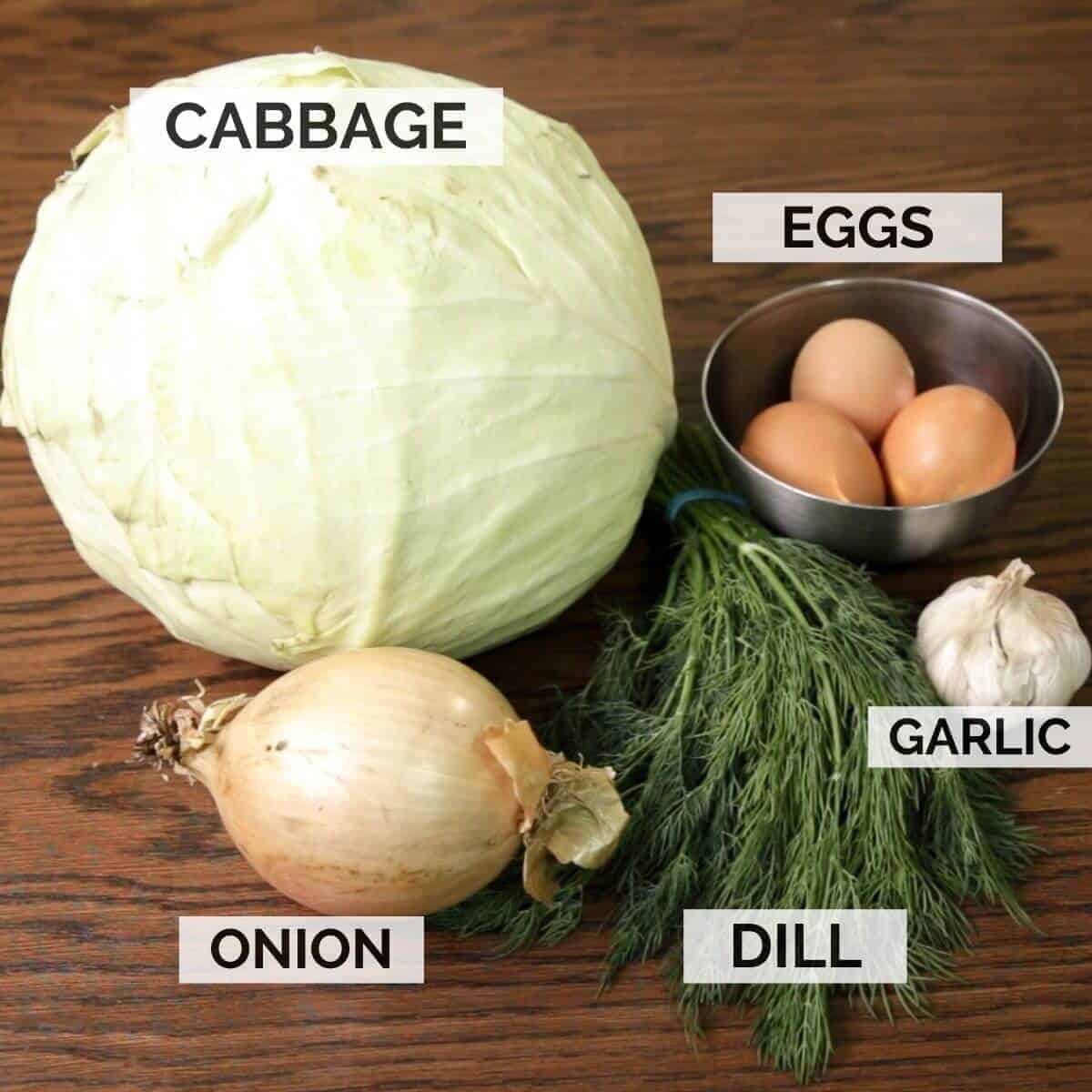 Ingredients for making cabbage piroshki filling on a dark wooden surface.