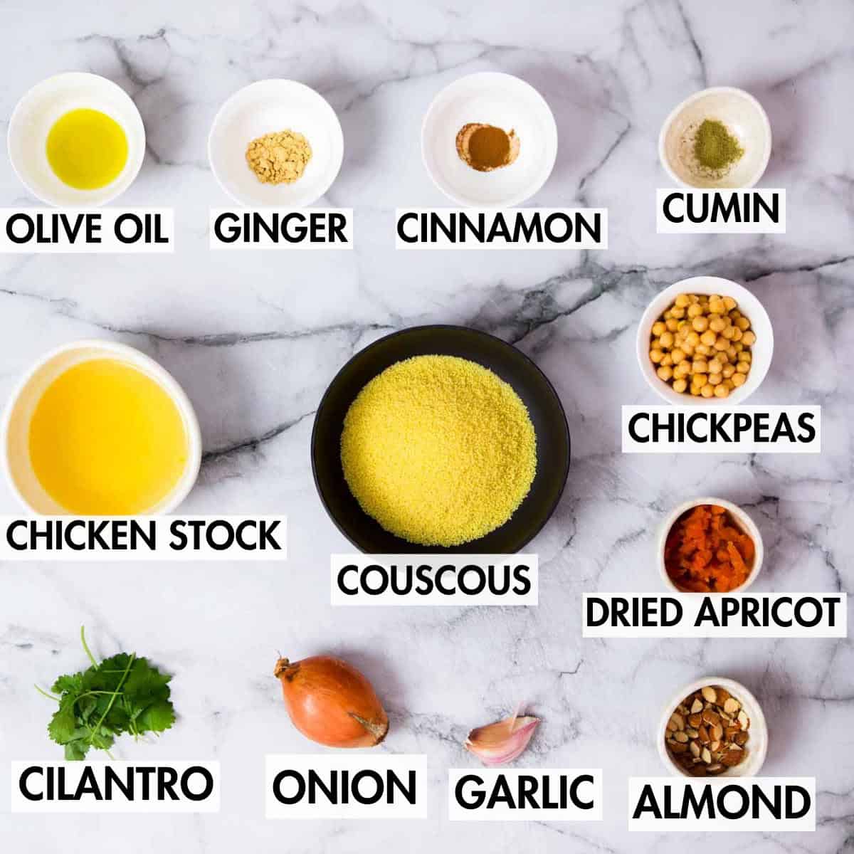 Ingredients for making Moroccan spiced couscous on a marble surface.