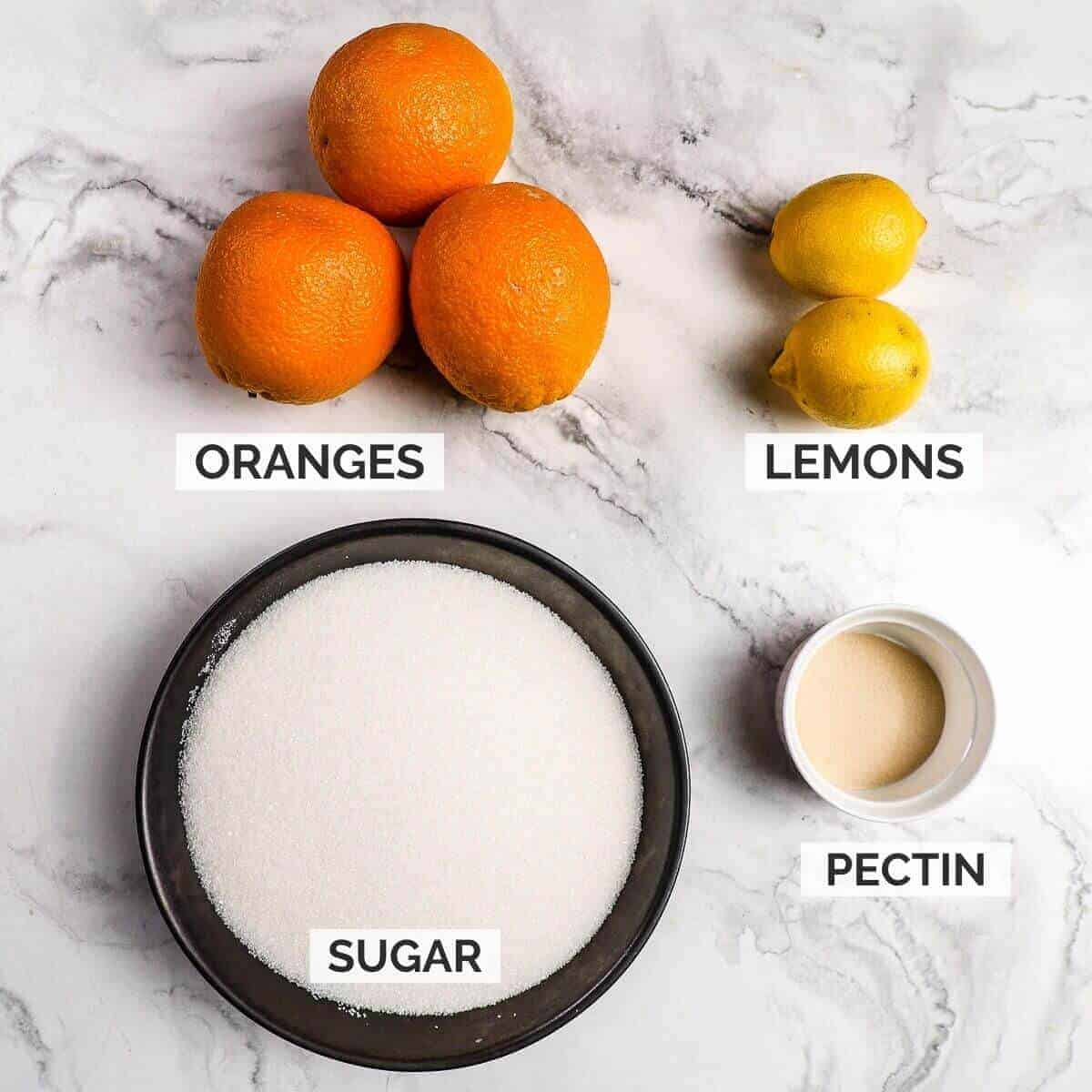 Ingredients-for-making-orange-marmalade-on-marble-background.