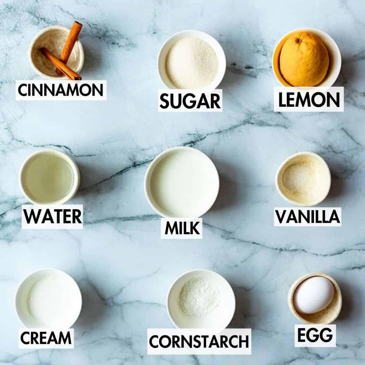 Ingredients for custard on a marble surface.