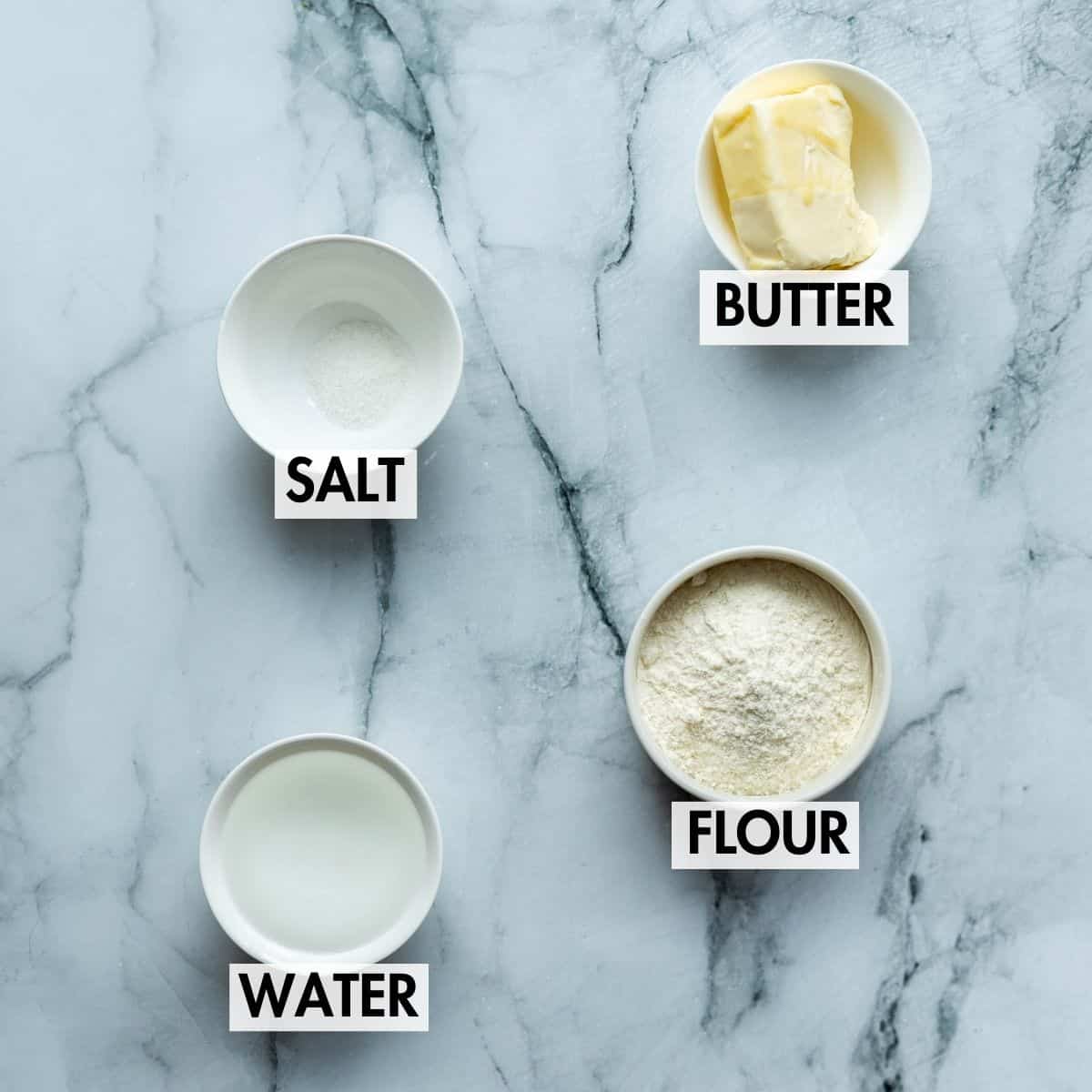 Ingredients for pastry on a marble surface.