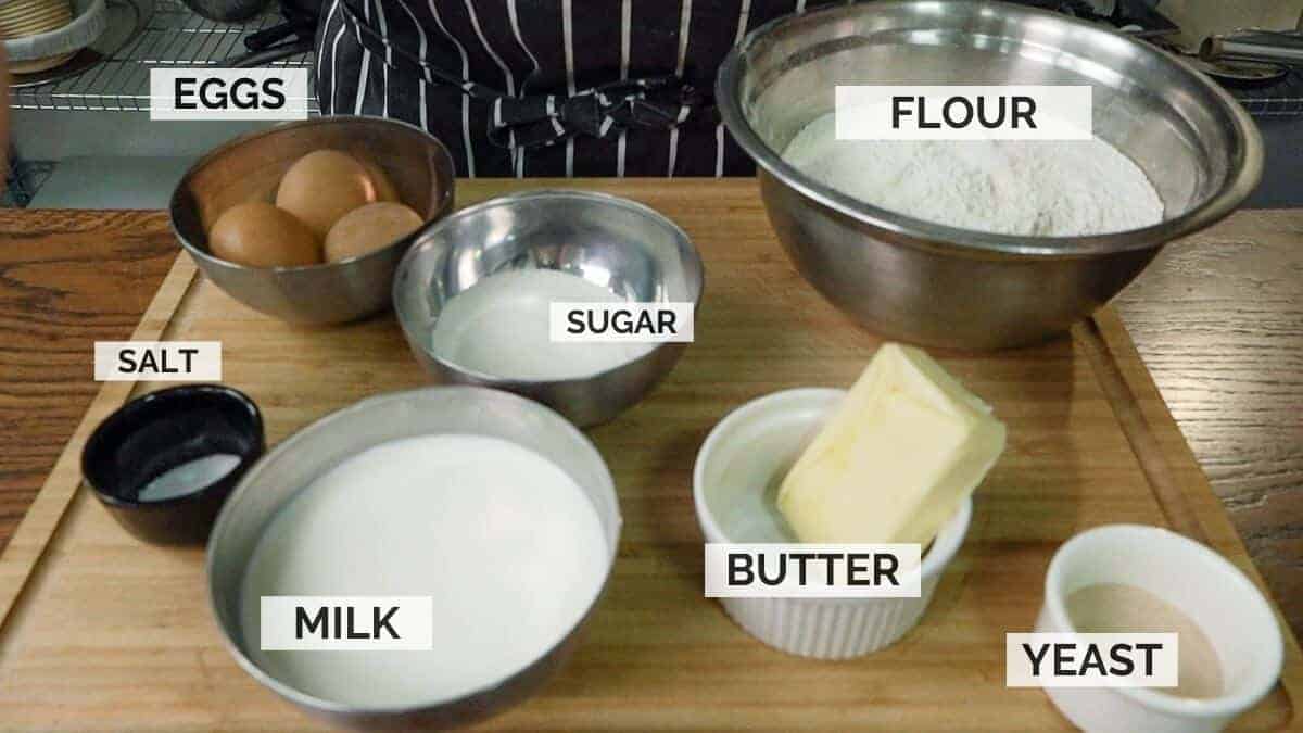 Ingredients for making Russian piroshki dough on a wooden surface.