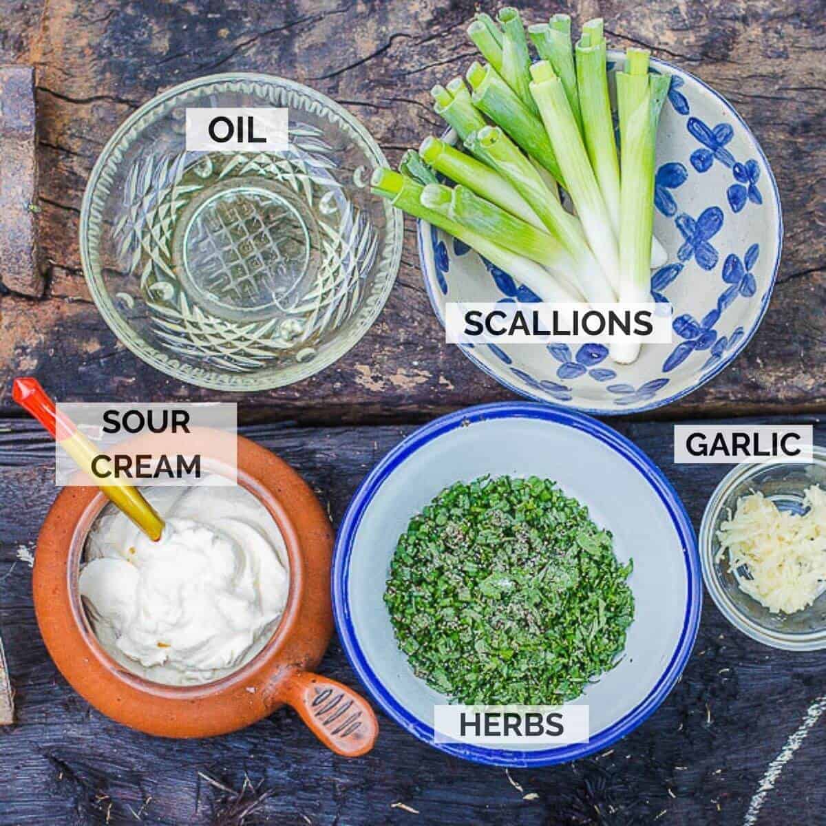 ingredients for finishing borscht omn a wooden board.