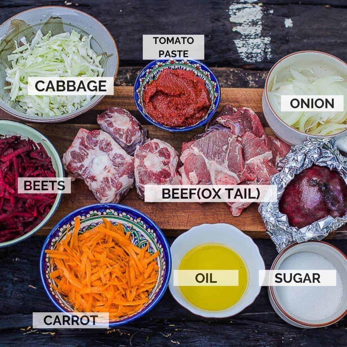 ingredients for making borscht on a wooden board.