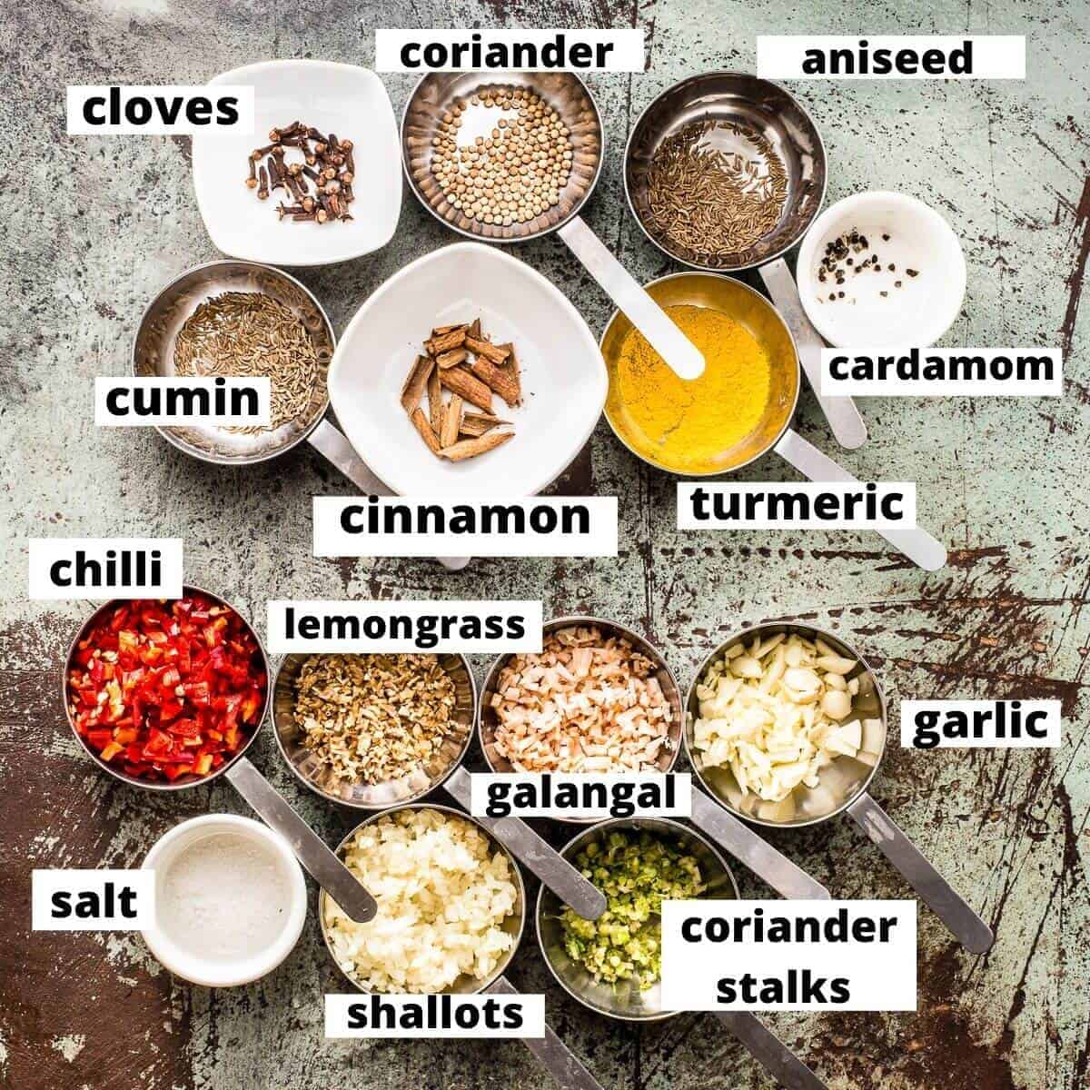 massaman curry paste ingredients on marble background.