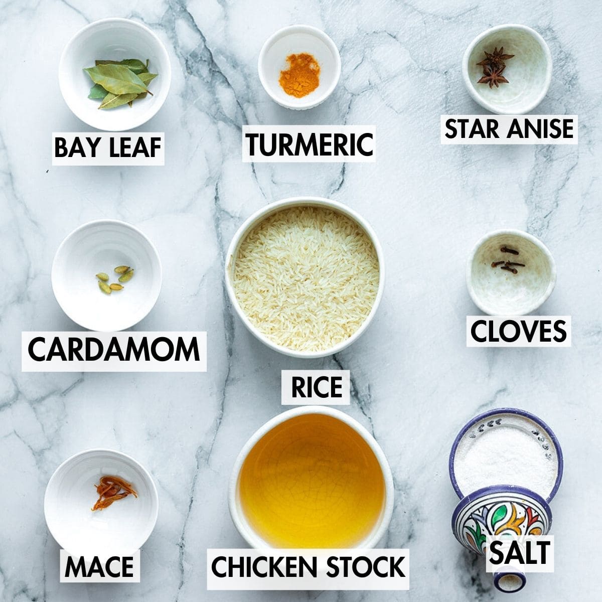 Ingredients for making biryani rice on a marble surface.