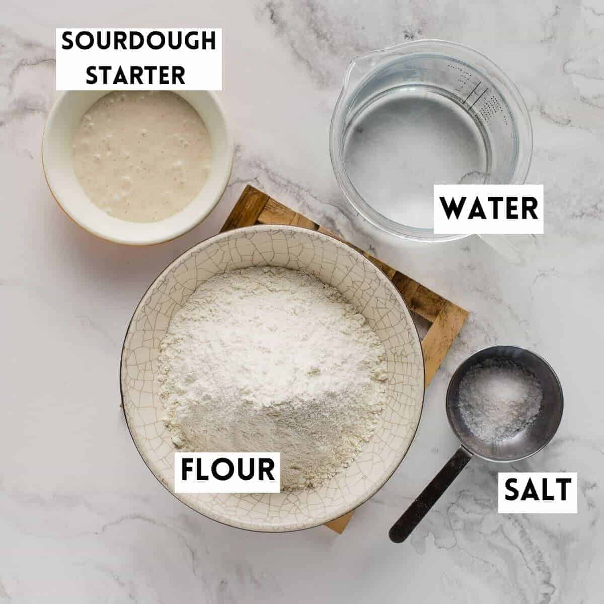 flour, water, salt and sourdough starter in separate bowls