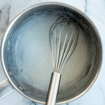 Cooked rice flour slurry in a sauce pan with a whisk.