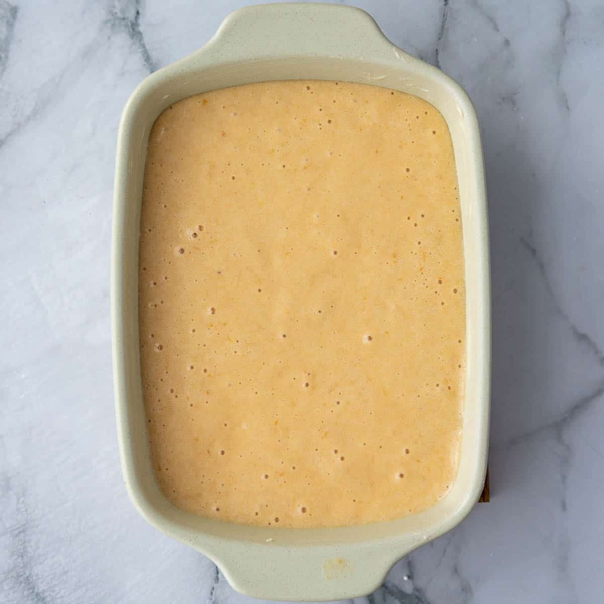 Dish filled with cake batter.