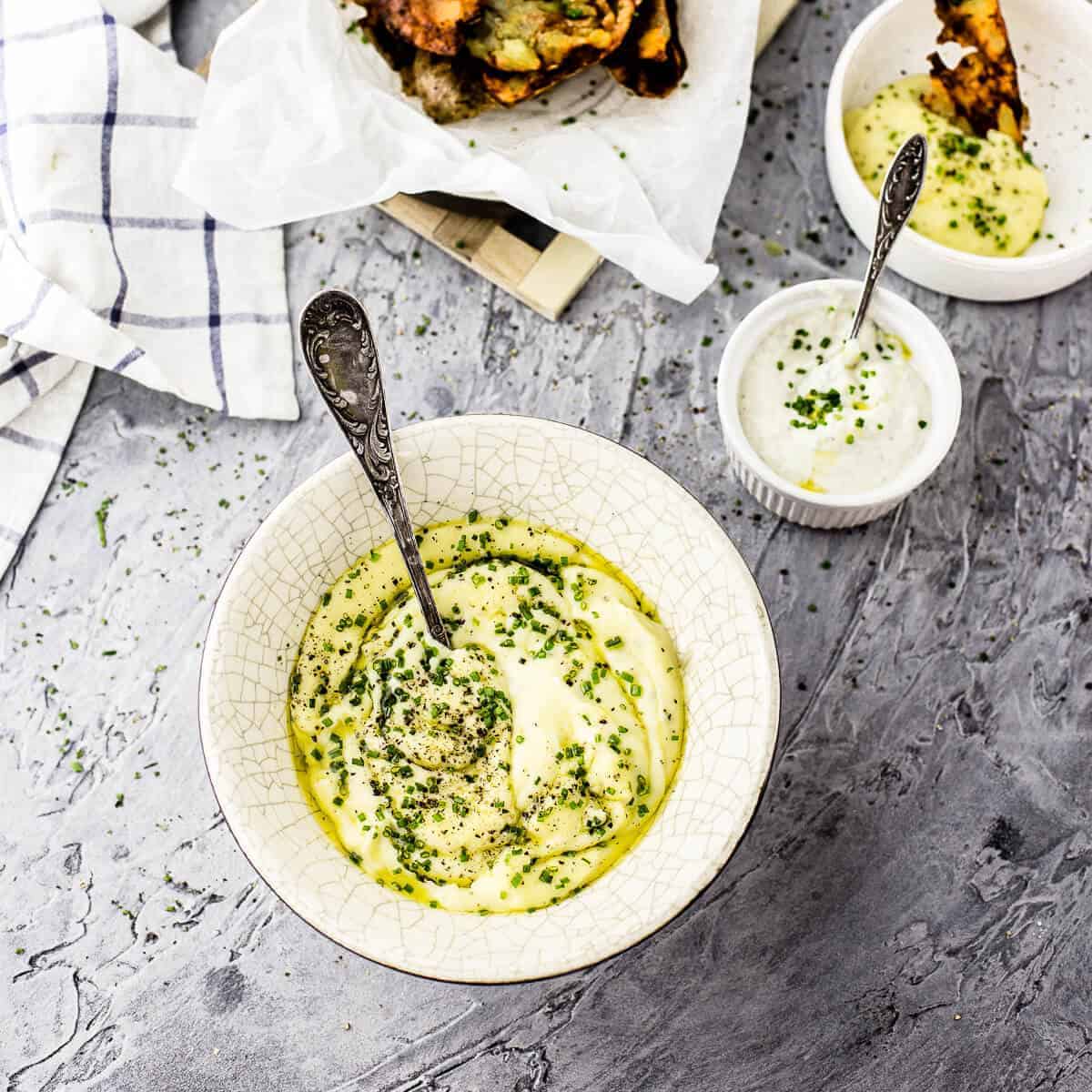 mashed potatoes. sourcream dip and crispy potato skins on grey background