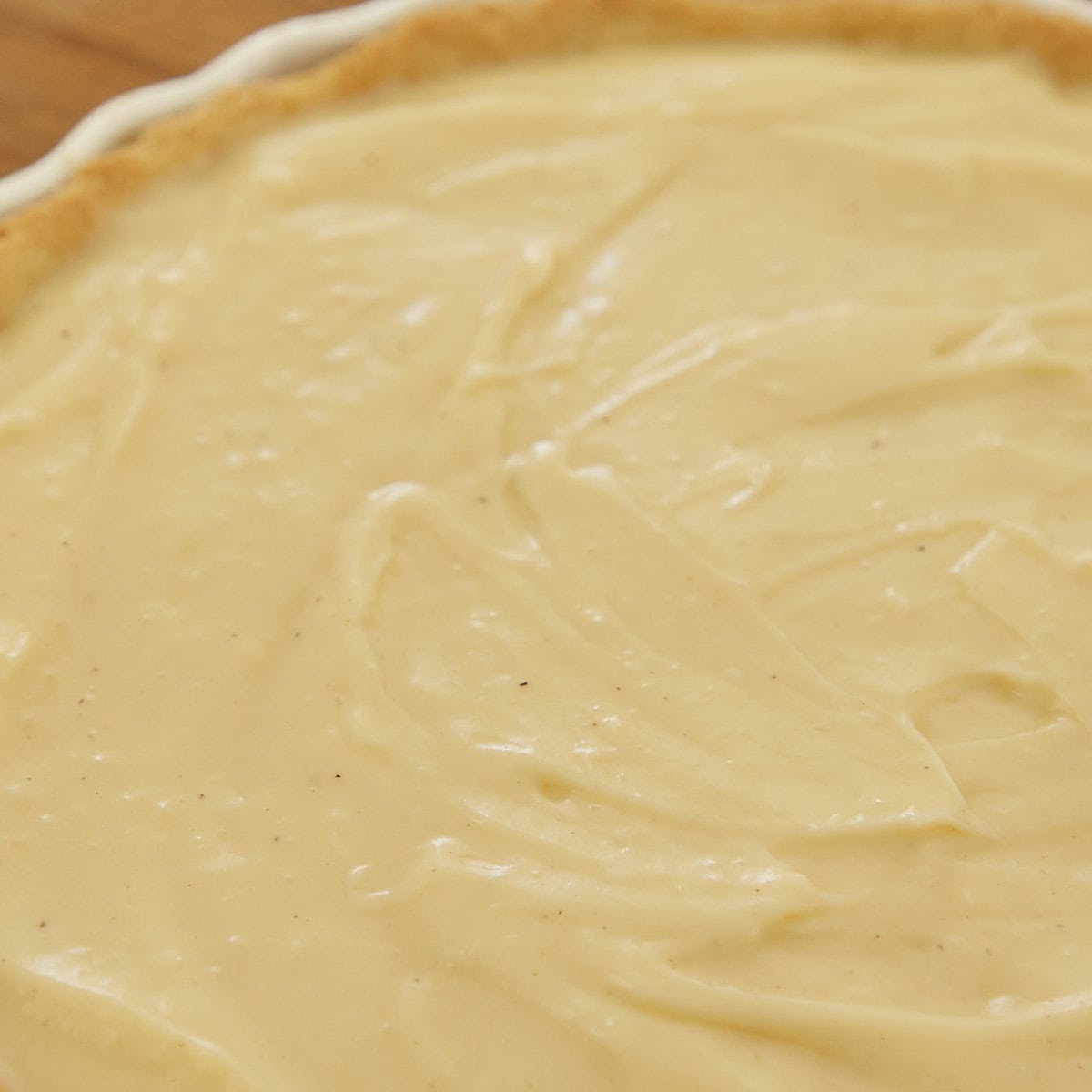 Custard filling in tart shell ready to bake.