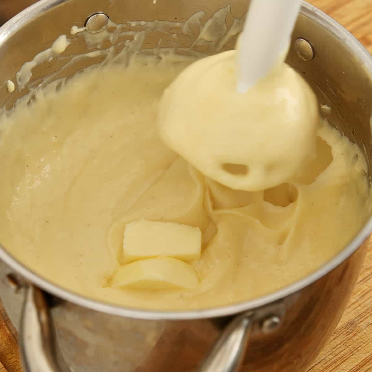 Butter being blended into custard filling.