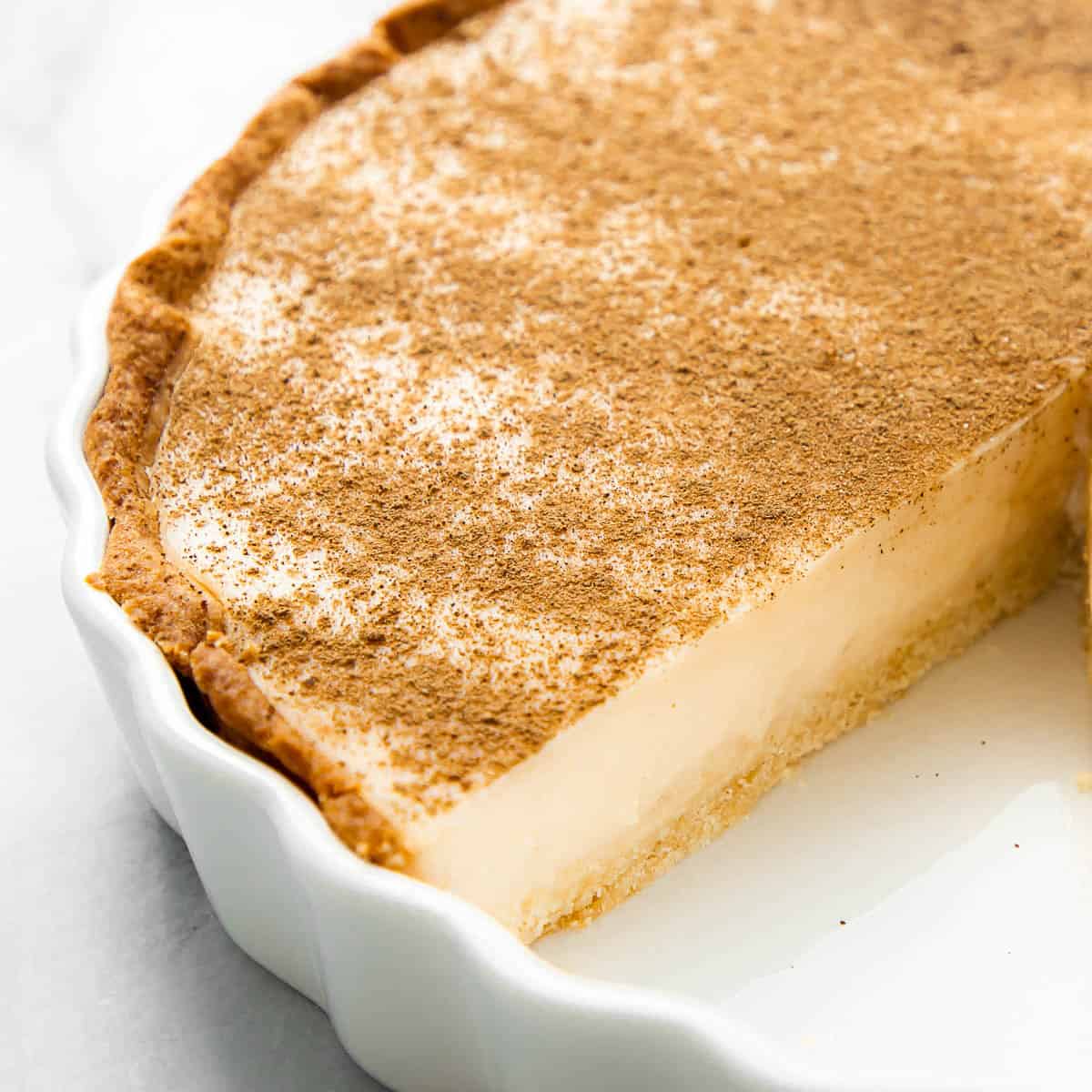Milk tart in a white baking dish.