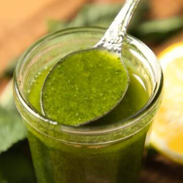 Fresh mint salad dressing in a glass jar.