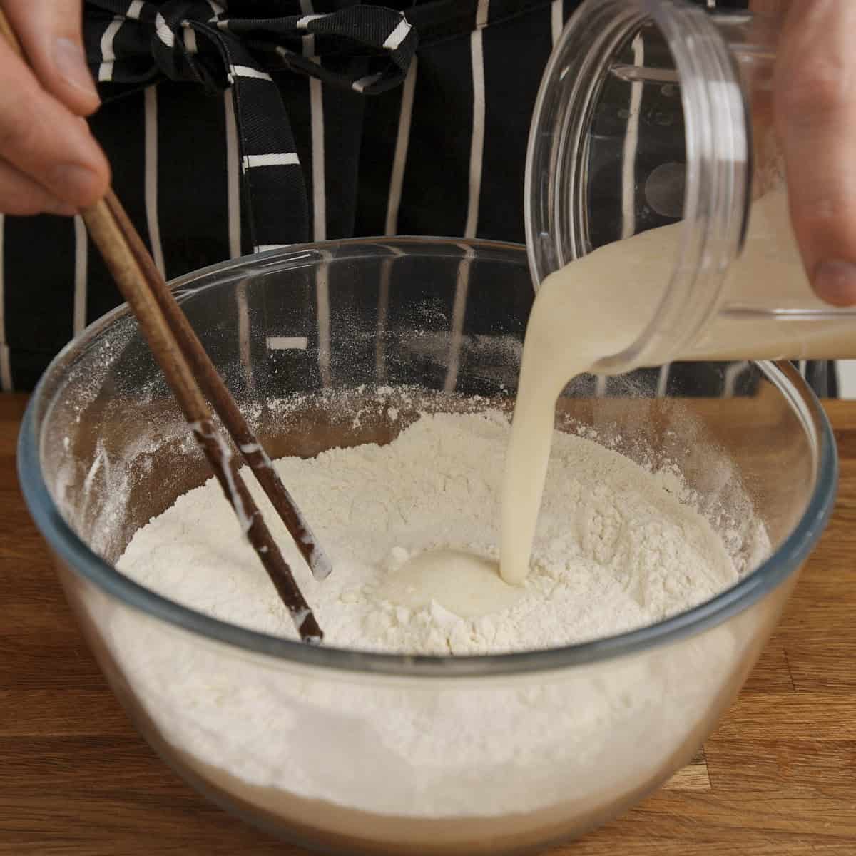 Adding bloomed yeasted liquid to flour.