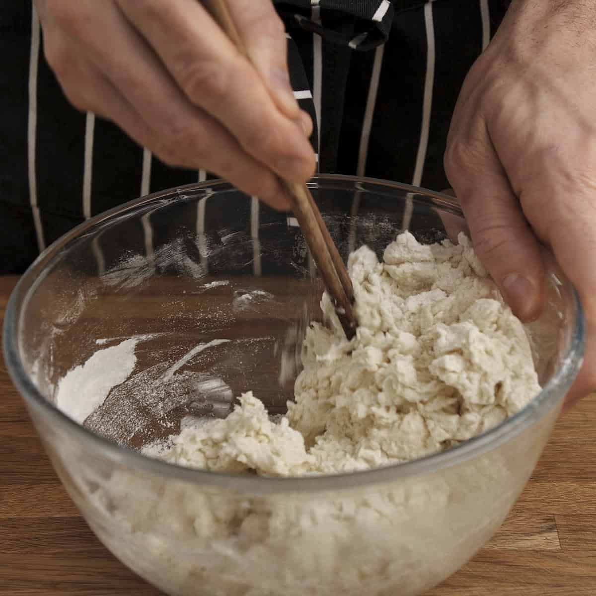 Initial mixing of liquids and flour for naan.