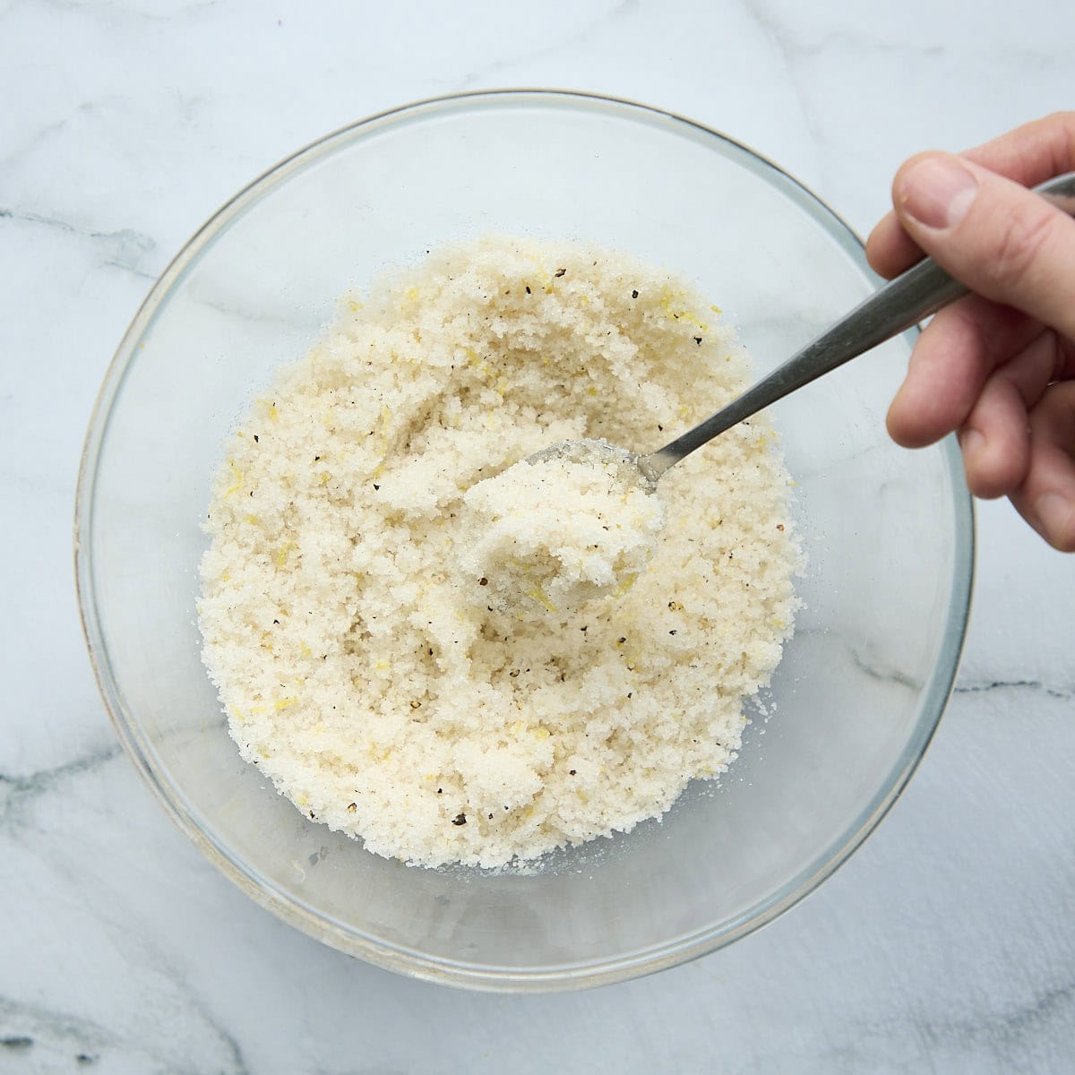 Mixing cure mixture with a spoon.