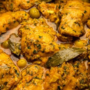 Moroccan lemon chicken in gravy with olives and bay leaves.