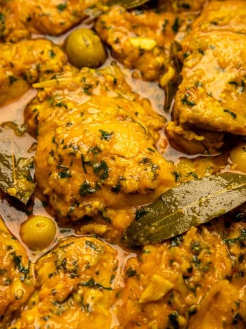 Moroccan lemon chicken in gravy with olives and bay leaves.