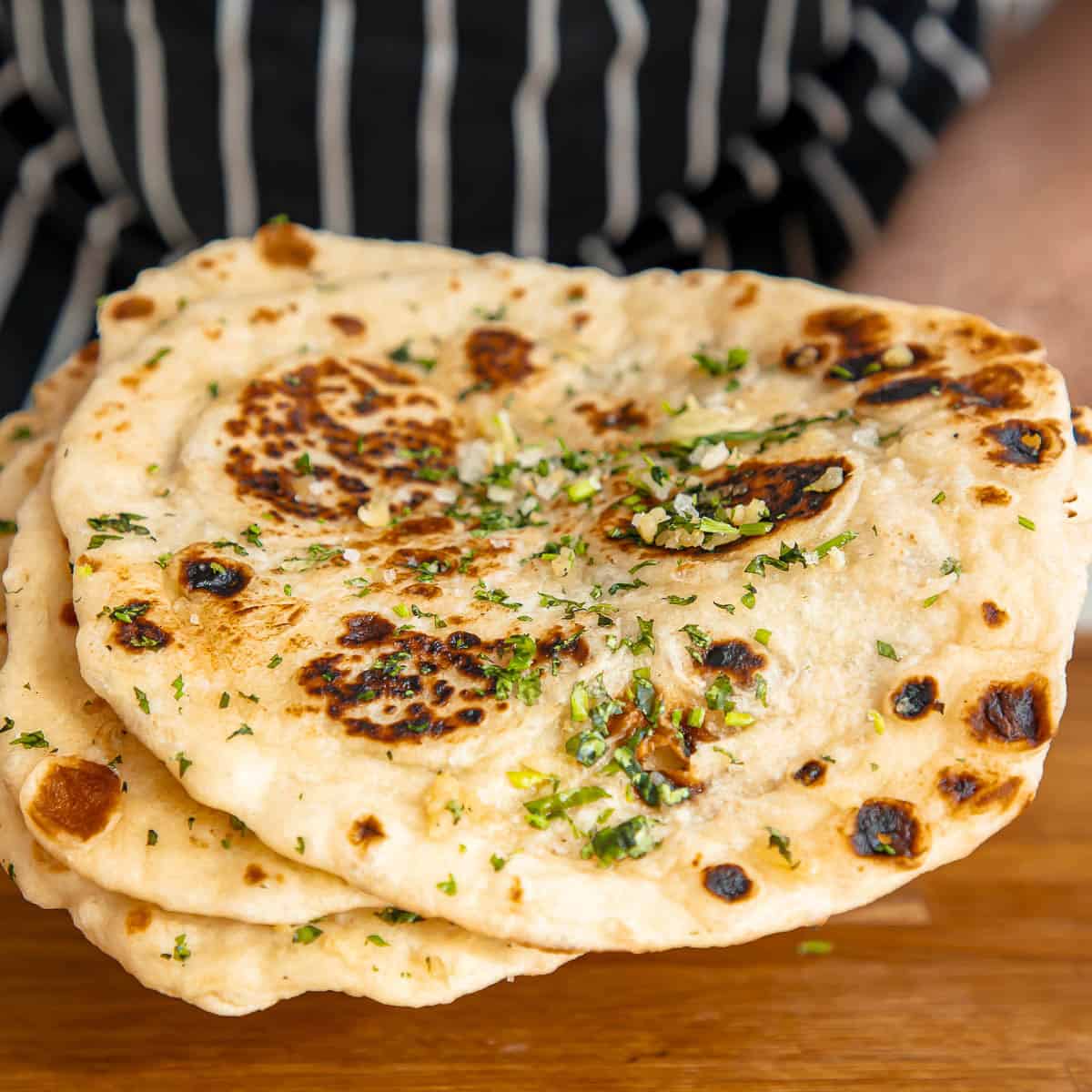 Naan breads with garlic butter and cilantro.
