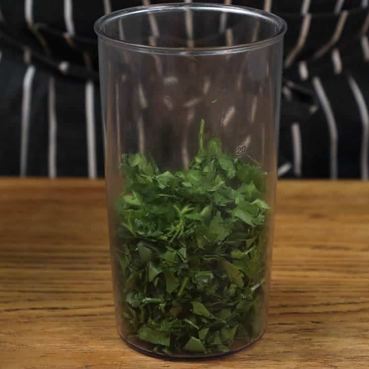 Blender jug with parsley.