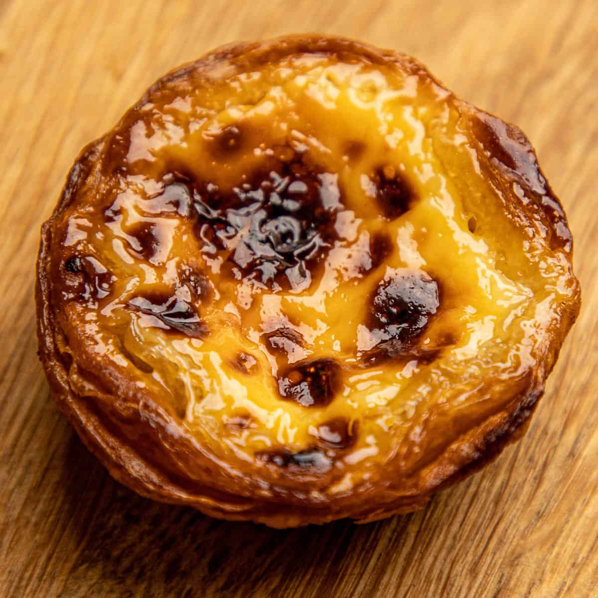 Pastel de nata on a wooden board.