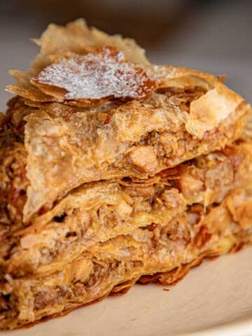 Moroccan pastilla chicken pie on a white plate.