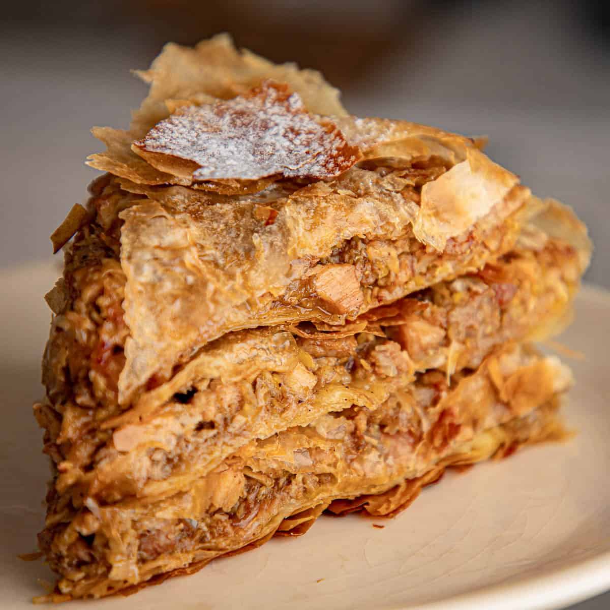 Moroccan pastilla chicken pie on a white plate.