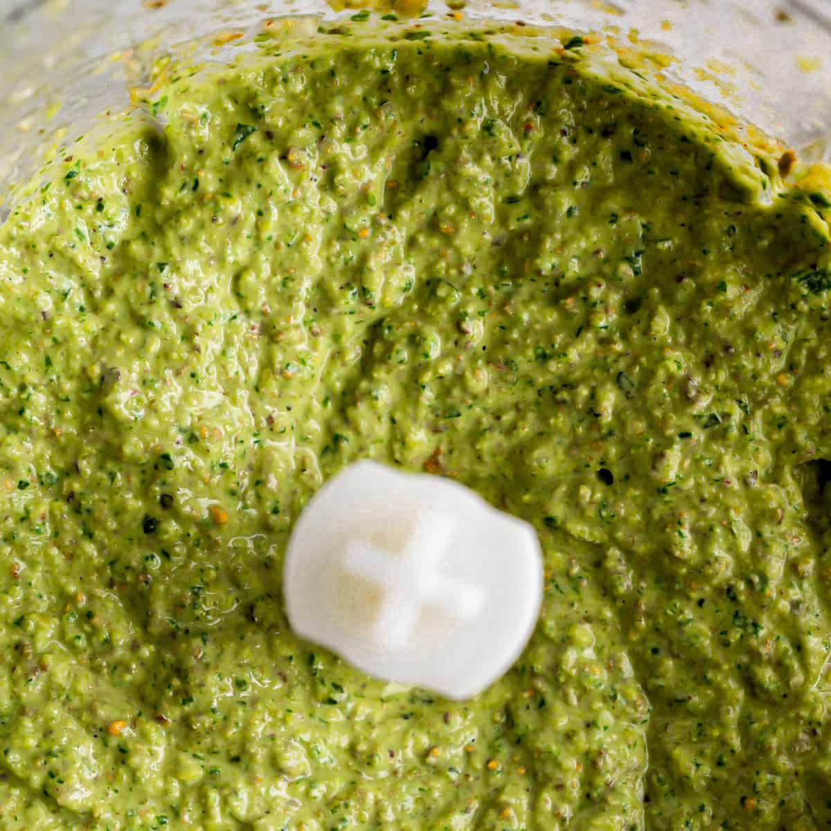 Pistachio pesto blending in a blender.